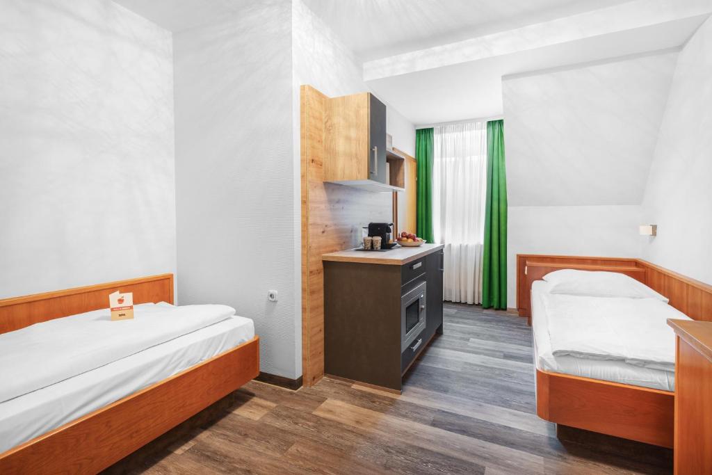 Postel nebo postele na pokoji v ubytování Schieners Hotel & Apfelhof Apartments