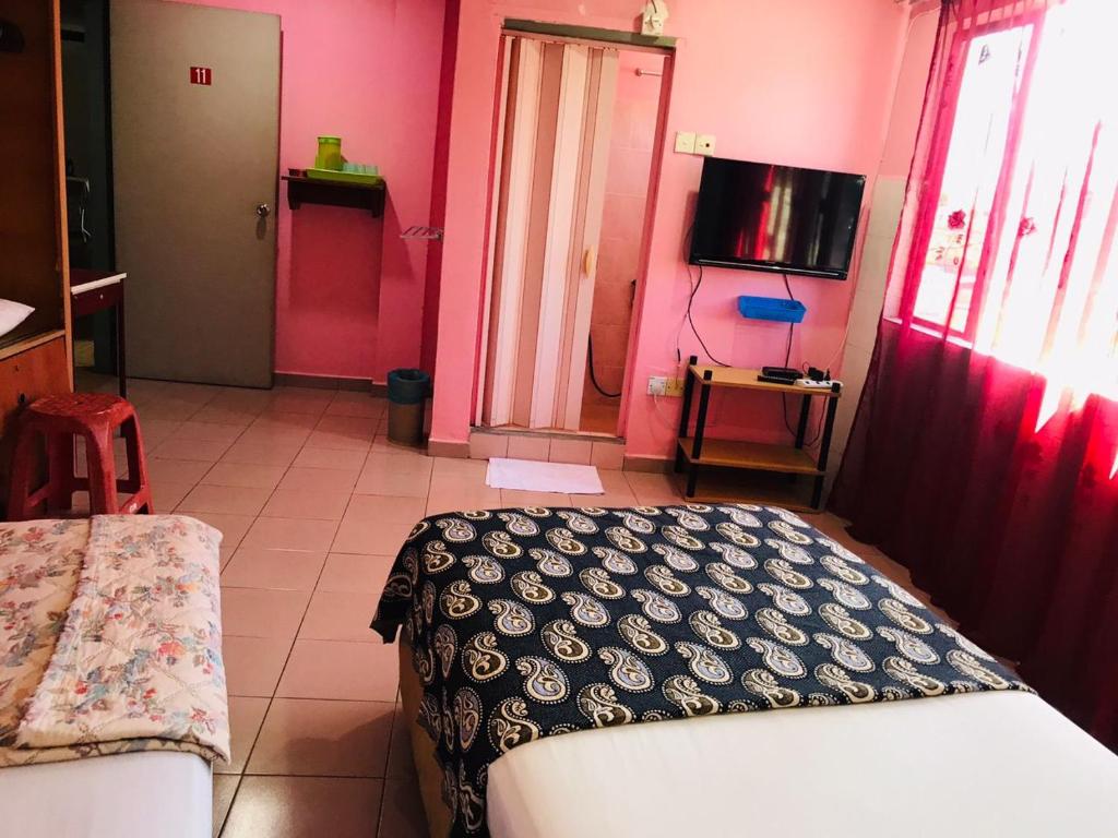 Postel nebo postele na pokoji v ubytování Hotel Cahaya