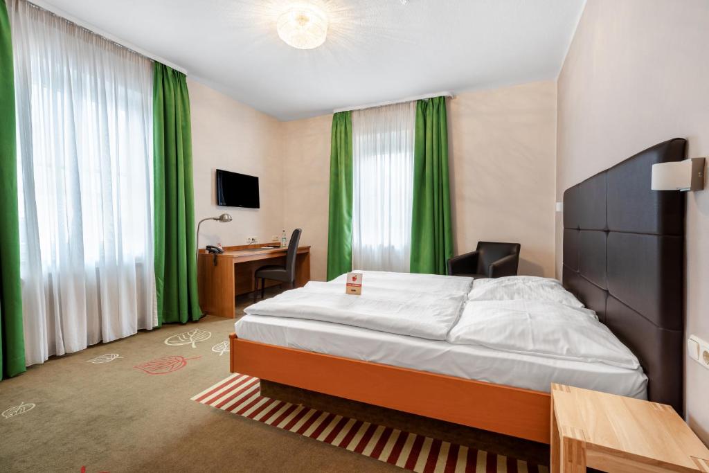 Postel nebo postele na pokoji v ubytování Schieners Hotel & Apfelhof Apartments
