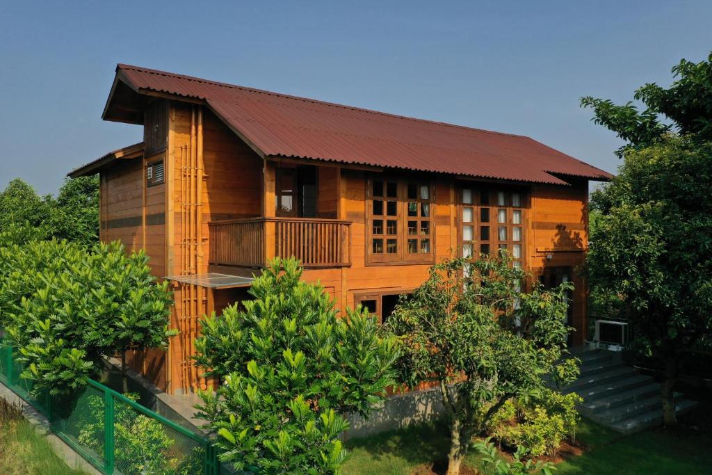 a wooden house with a red roof at The Pine Loft in Bangalore