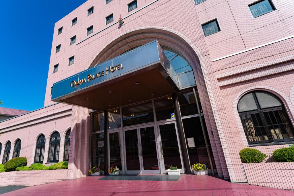 a building with a sign on the front of it at Oyama Palace Hotel in Oyama