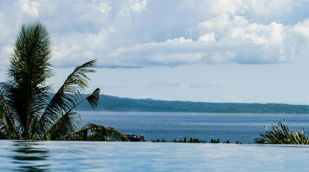 a swimming pool with a view of the water at NEANO ESCAPE in Manggis