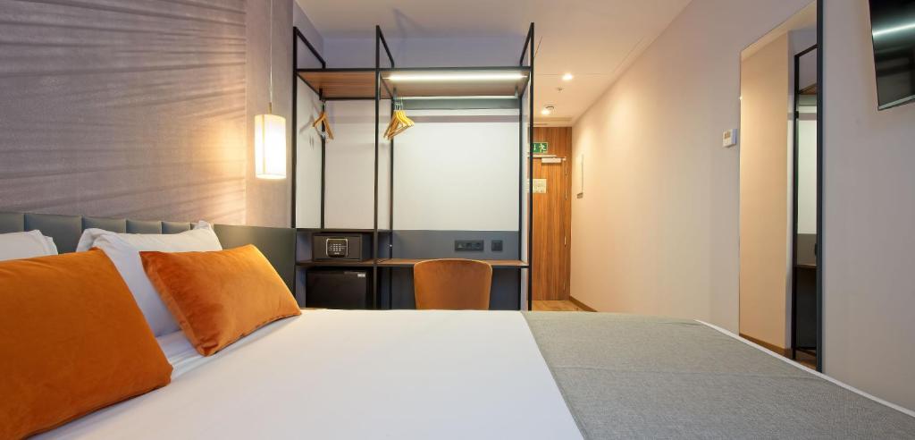 A bed or beds in a room at DWO Yuste Alcalá