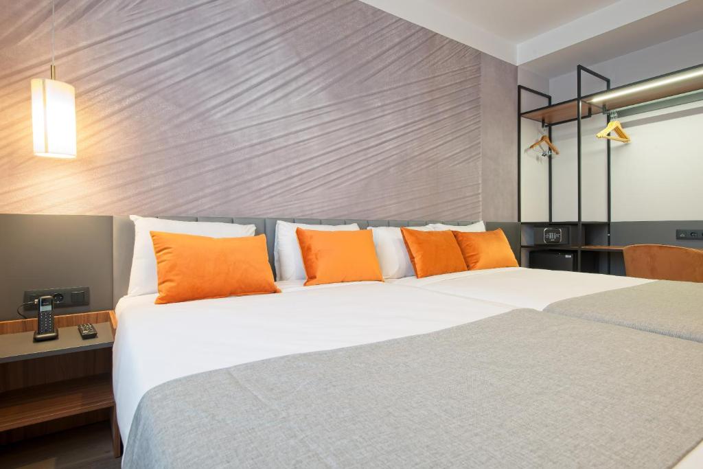 A bed or beds in a room at DWO Yuste Alcalá