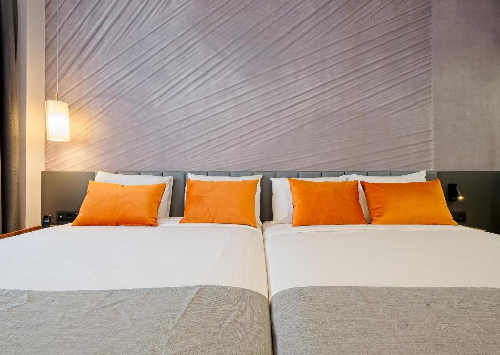 A bed or beds in a room at DWO Yuste Alcalá