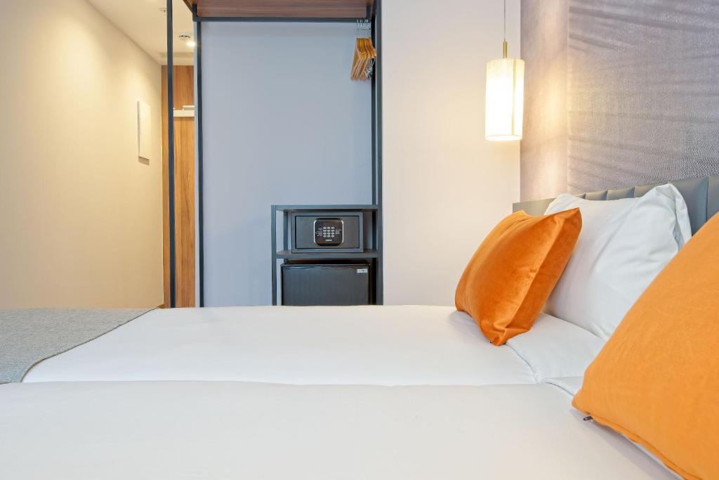 A bed or beds in a room at DWO Yuste Alcalá