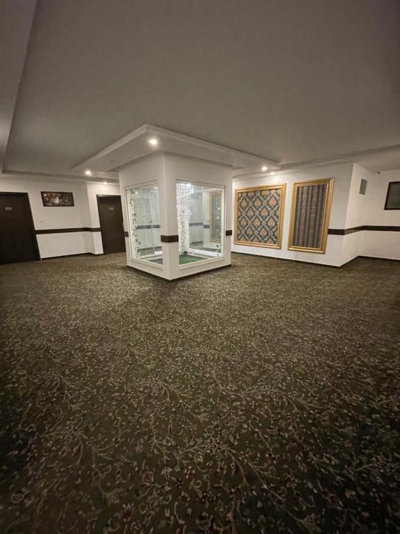 a room with a large room with a large floor at Grand Mongolia Hotel in Rawalpindi