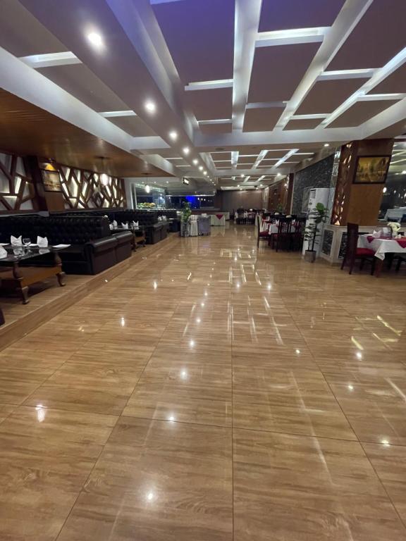 a dance floor with lights on it in a restaurant at Grand Mongolia Hotel in Rawalpindi
