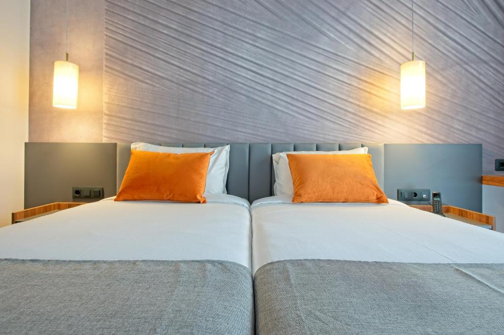 A bed or beds in a room at DWO Yuste Alcalá