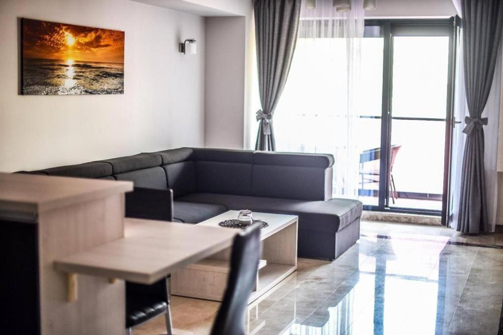 a living room with a couch and a table at Apartament Mamaia Nord VS14 in Mamaia
