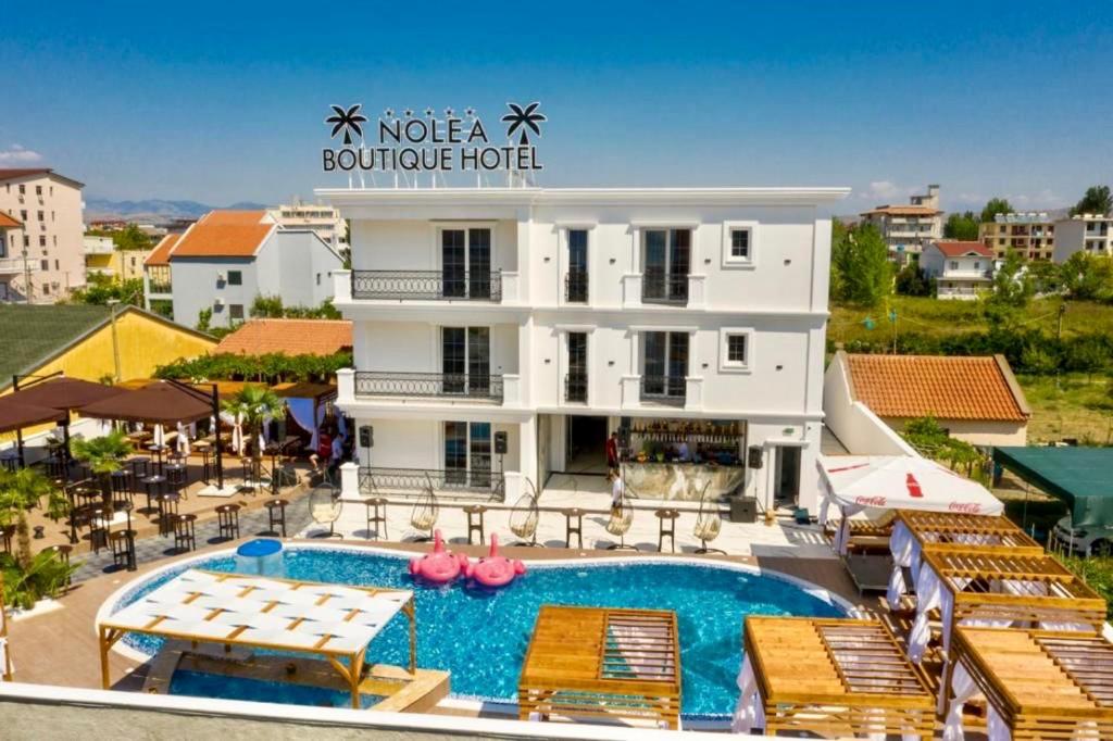 a view of a hotel with a pool and chairs at NOLEA Boutique Hotel in Velipojë