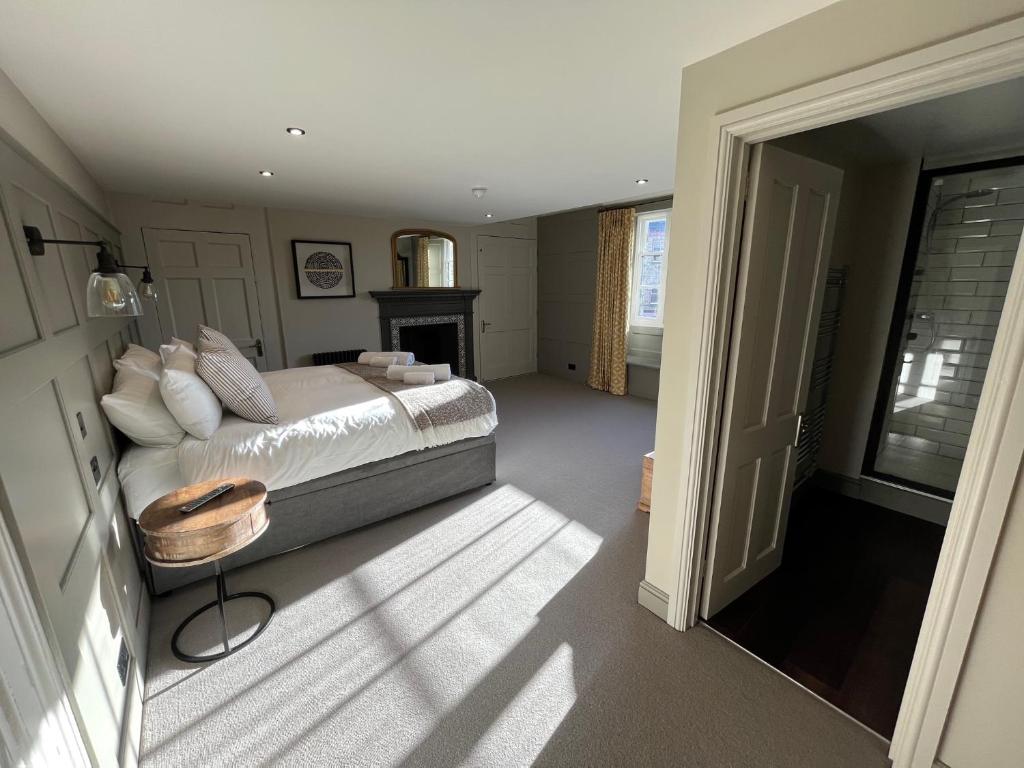 a bedroom with a bed and a fireplace and a window at The Punchbowl Inn in Woodstock