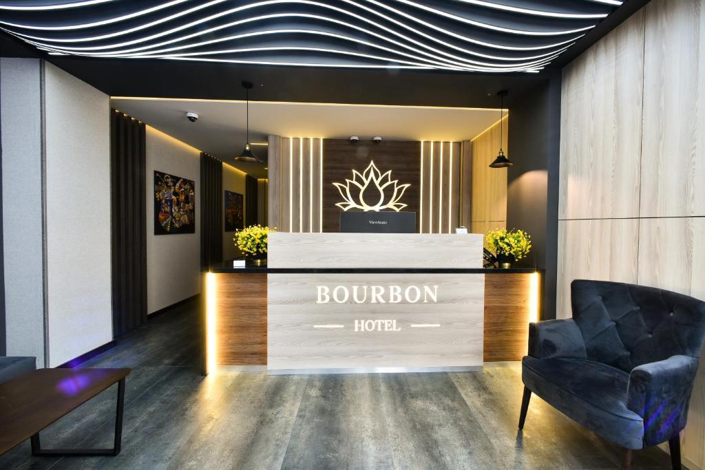 a lobby with a burrow hotel sign and a chair at Bourbon Boutique Hotel in Yerevan