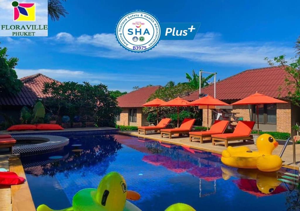 a pool at a villa with rubber ducks in the water at Flora Ville-SHA PLUS in Chalong