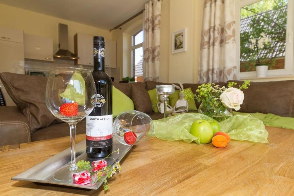 a bottle of wine sitting on top of a table at Ostseeperlen-Haus 1 in Kühlungsborn