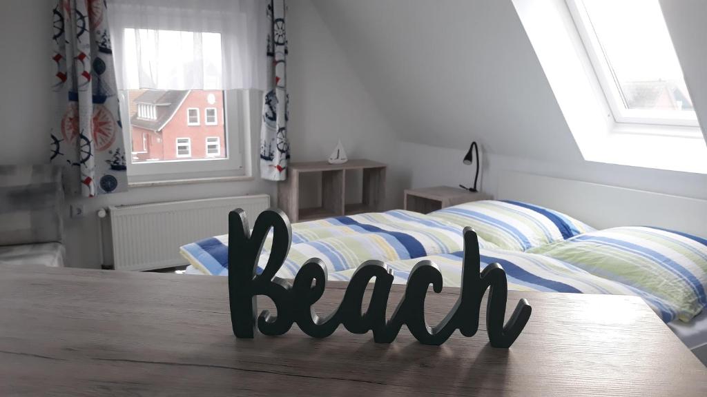 a bedroom with a bed with a sign that reads rail at Seevilla Wietjes Whg 7 in Baltrum