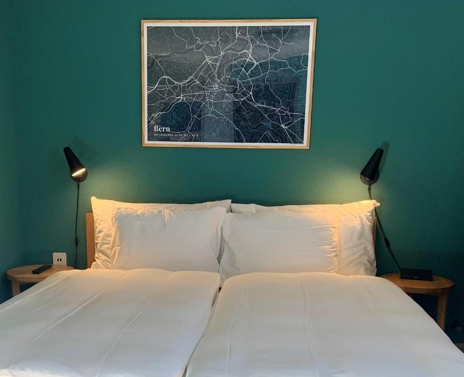 1 dormitorio con 2 camas blancas y una foto en la pared en 5th Floor Basic Rooms - shared bathrooms, en Interlaken