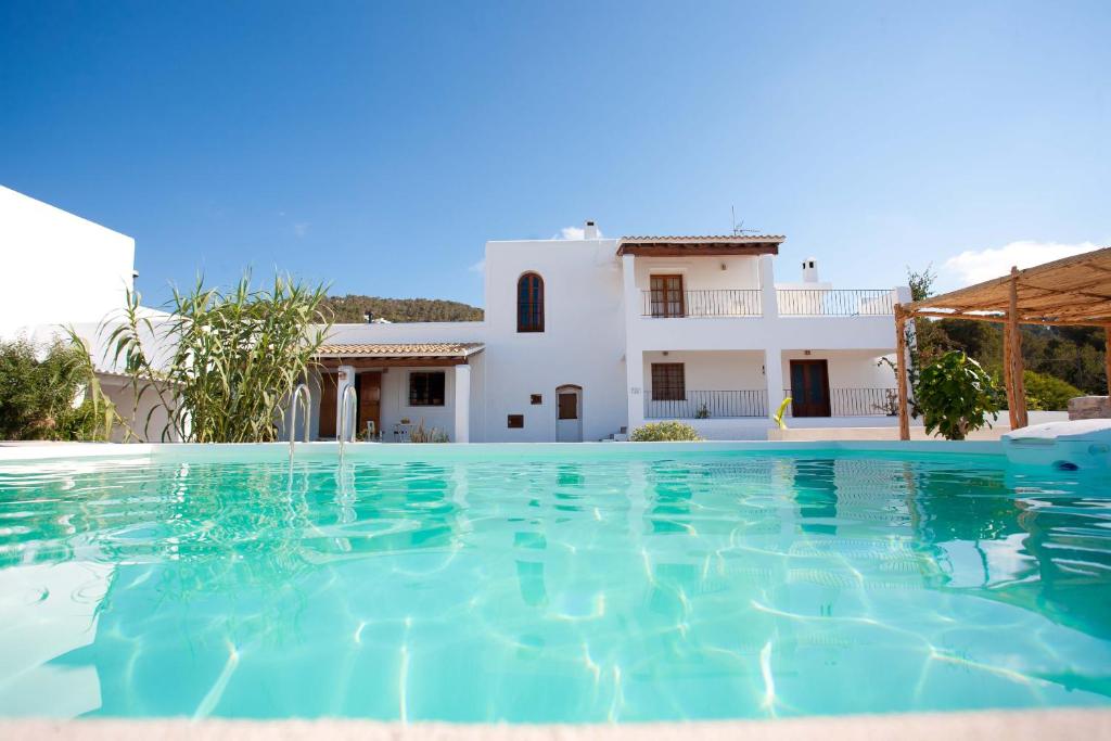 a villa with a swimming pool in front of a house at Villa Can Sunyer.Ibiza. in Ibiza Town