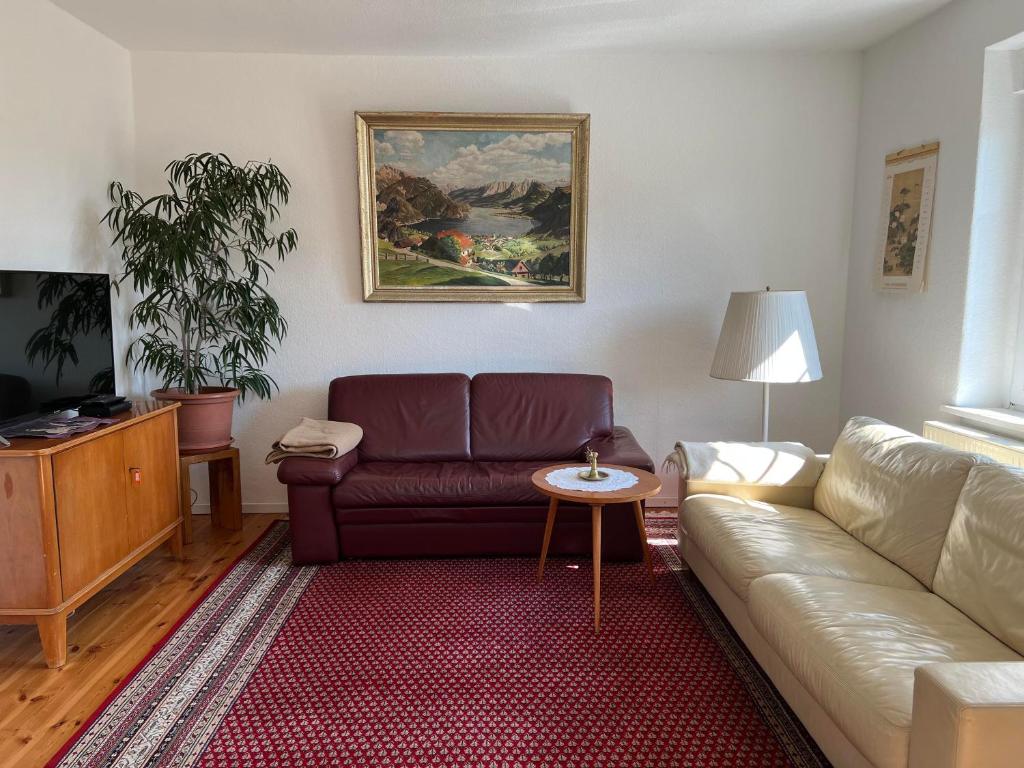 a living room with a couch and a table at Westfälischer Hof - 2nd floor 