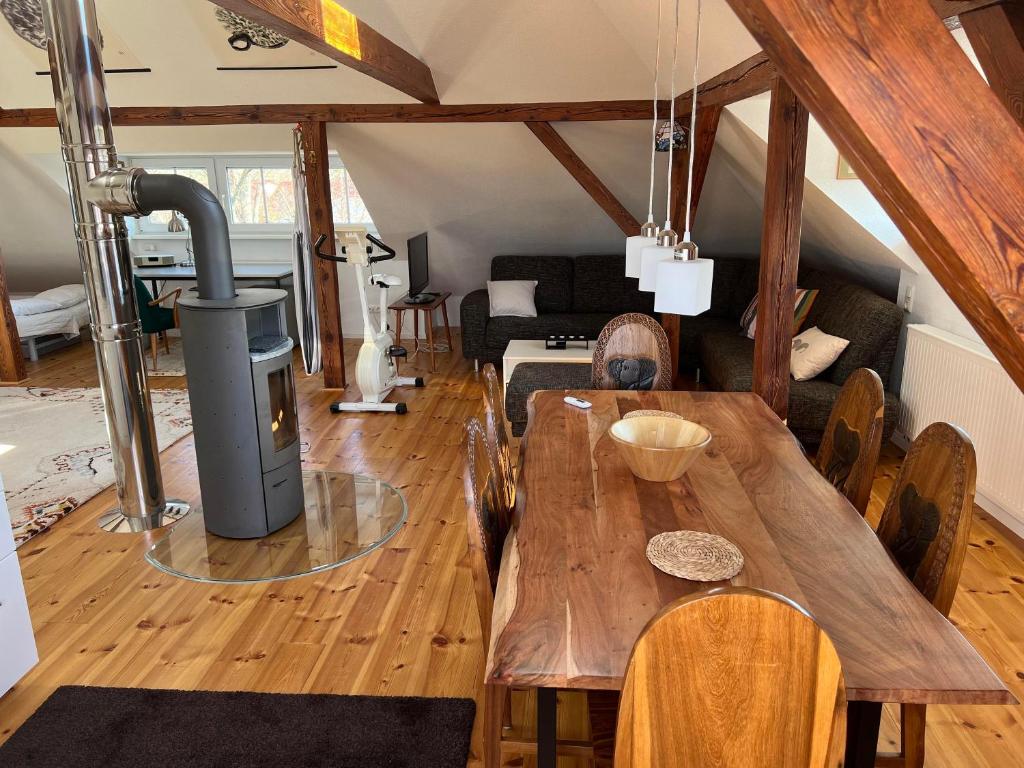 a room with a wooden table and a living room at Westfälischer Hof - Loft 