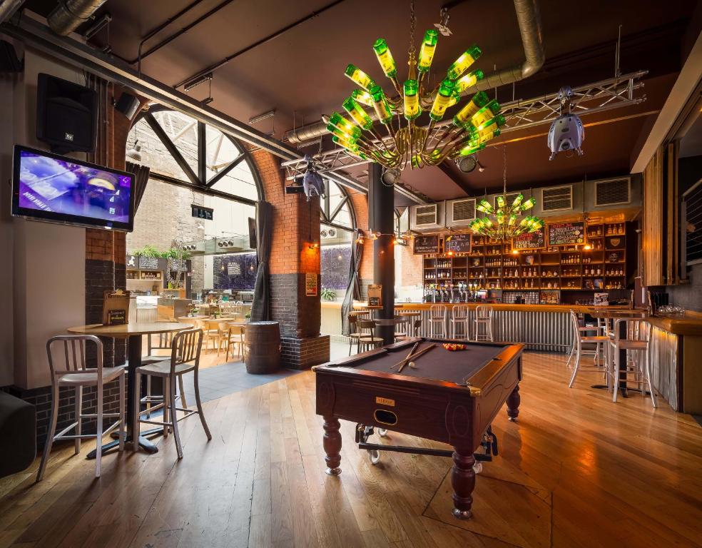 a pool table in a bar with a chandelier at Generator Dublin in Dublin