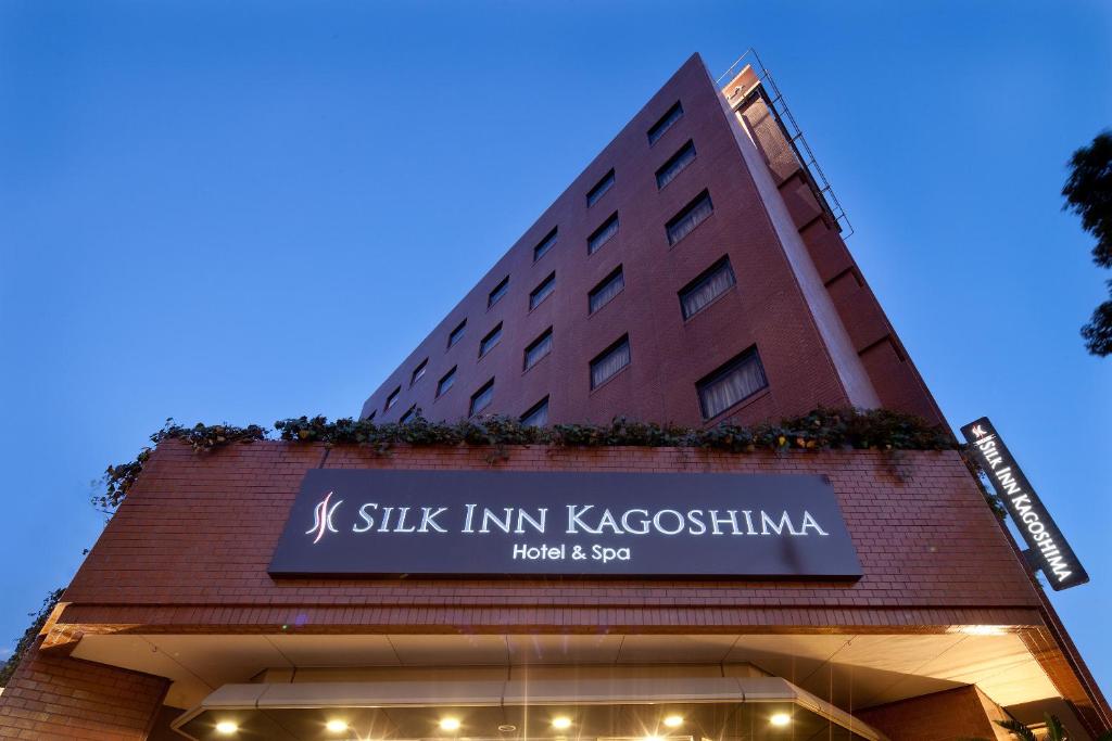 a sign on the side of a building at Silk Inn Kagoshima in Kagoshima