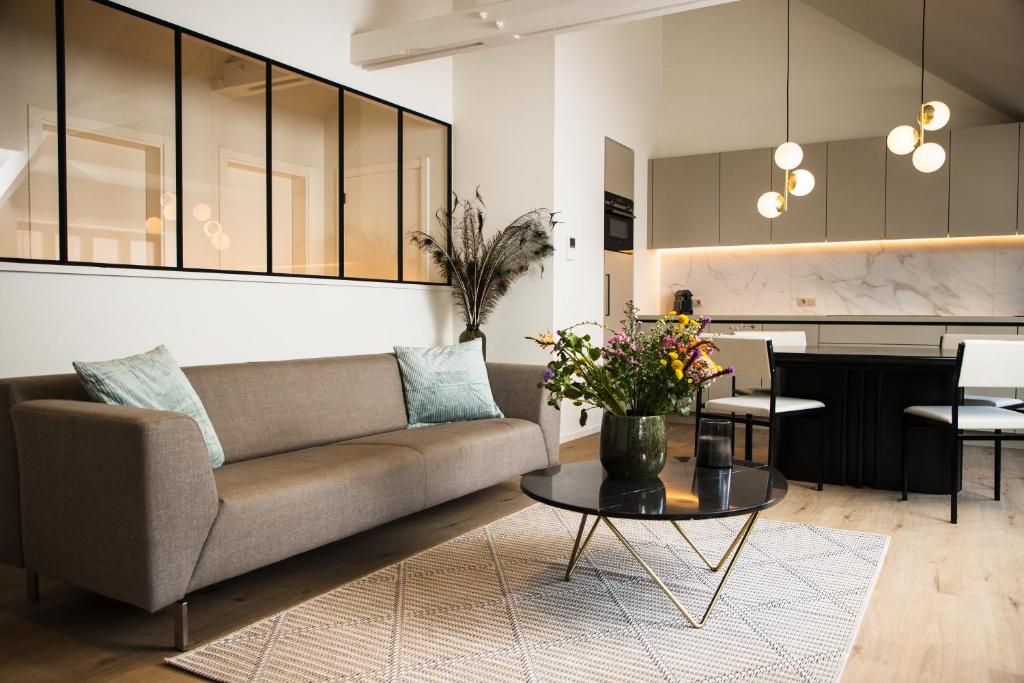 a living room with a couch and a table at The lodge Morris in Leuven