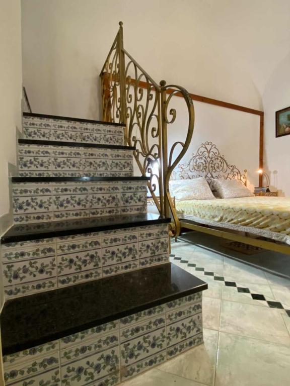 une chambre avec un escalier et un lit dans une pièce dans l'établissement Camera Buono, à Ischia