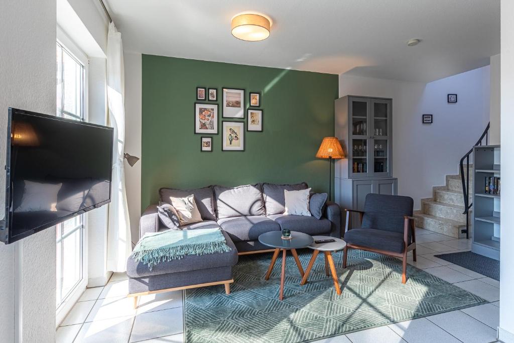 a living room with a couch and a tv at Ferienhaus Waldblick in Funfseen