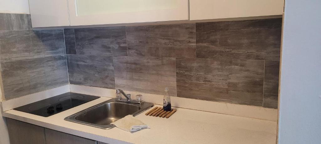 a kitchen with a sink and a counter top at Cond. St. Tropez in San Juan