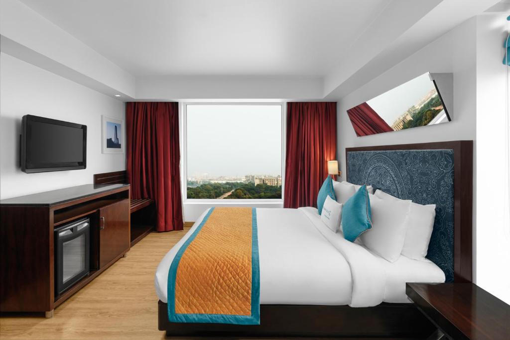 TV a/nebo společenská místnost v ubytování Golden Tulip City Centre Gurgaon