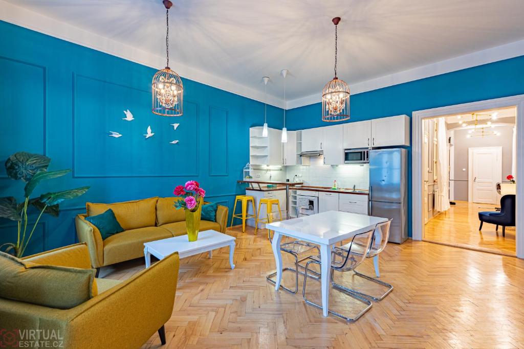 a living room with a couch and a table at Colorful Wenceslas square apartment in Prague