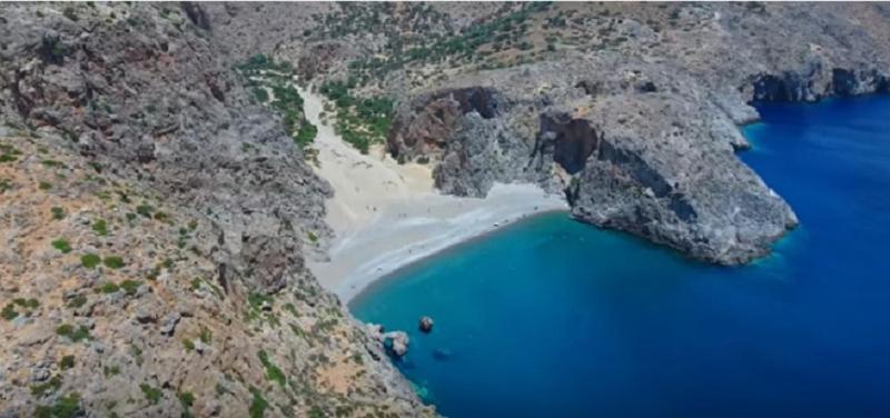 an aerial view of a rocky mountain with blue water at Theaktis Homes in Kaloi Limenes