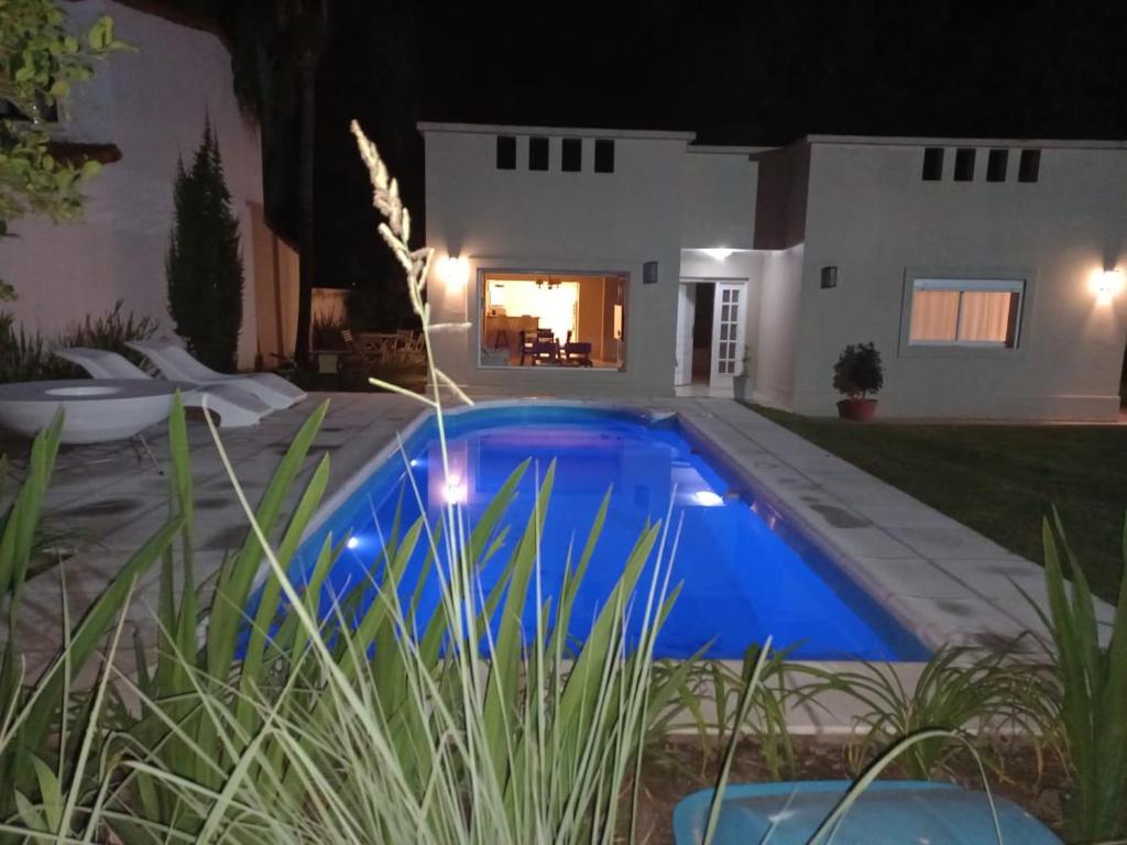 a swimming pool in front of a house at night at Casa San Lorenzo in San Lorenzo