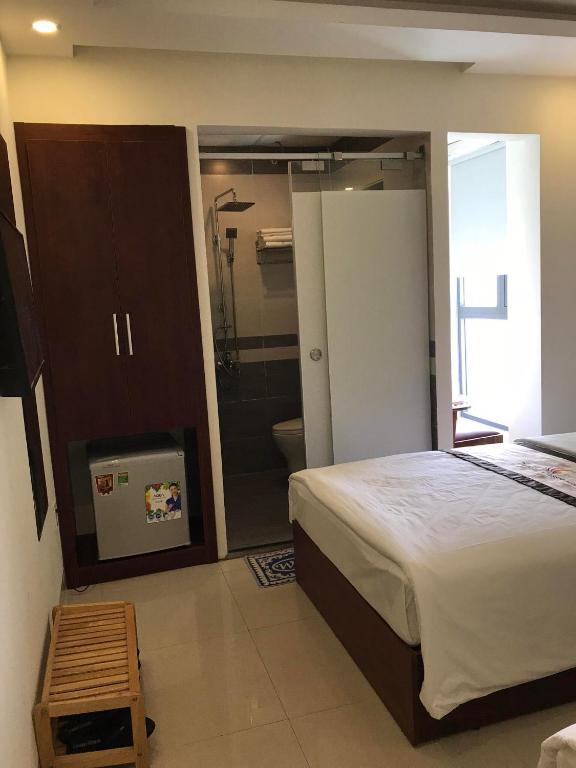 Postel nebo postele na pokoji v ubytování Danang Classic Hotel