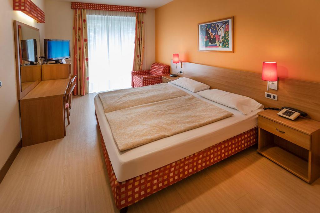 Posteľ alebo postele v izbe v ubytovaní Hotel Ideal