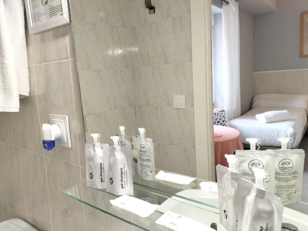 un baño con lavabo y espejo en Hostal Albero by gaiarooms, en Salamanca