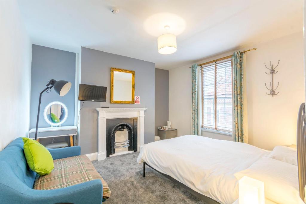 a bedroom with a bed and a fireplace at Minster Hub - 2 Min Walk 2 Minster! in York