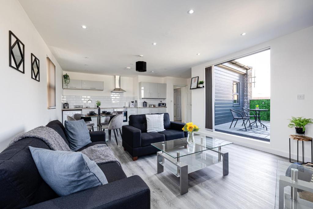 a living room with a couch and a table at Top Floor Apartment with Private Balcony in Stockport Centre by HASS HAUS in Stockport
