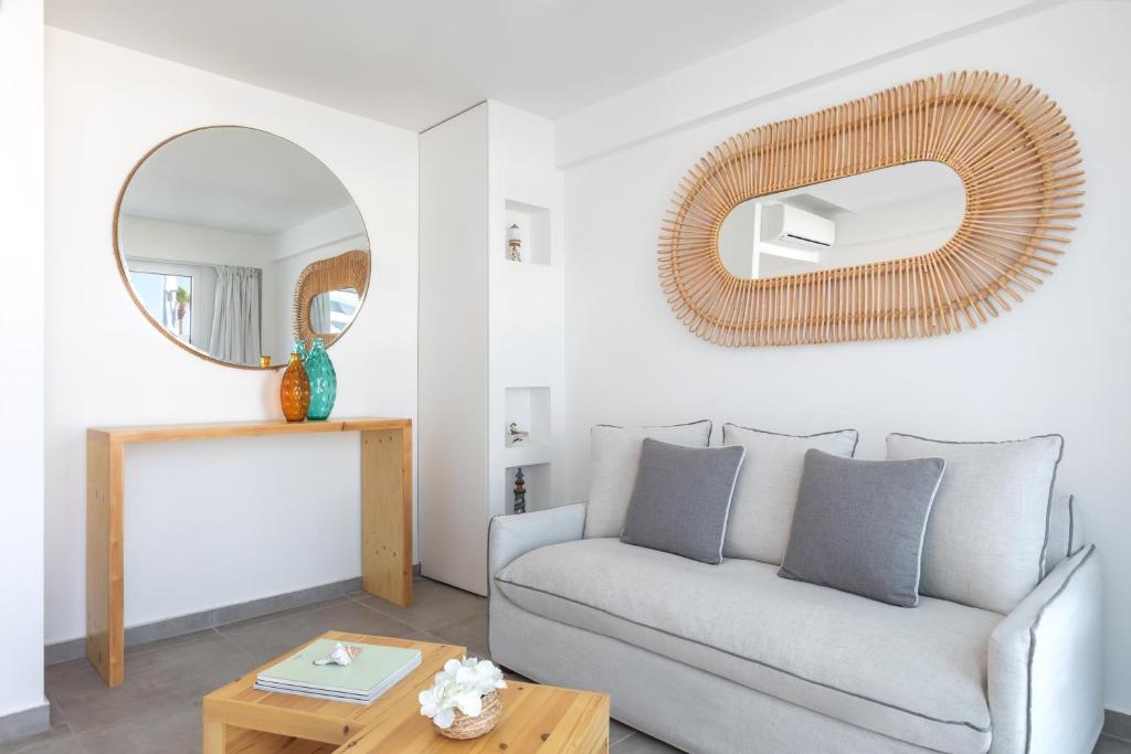 a living room with a couch and a mirror at Blue Harbour Boutique in Ayia Napa