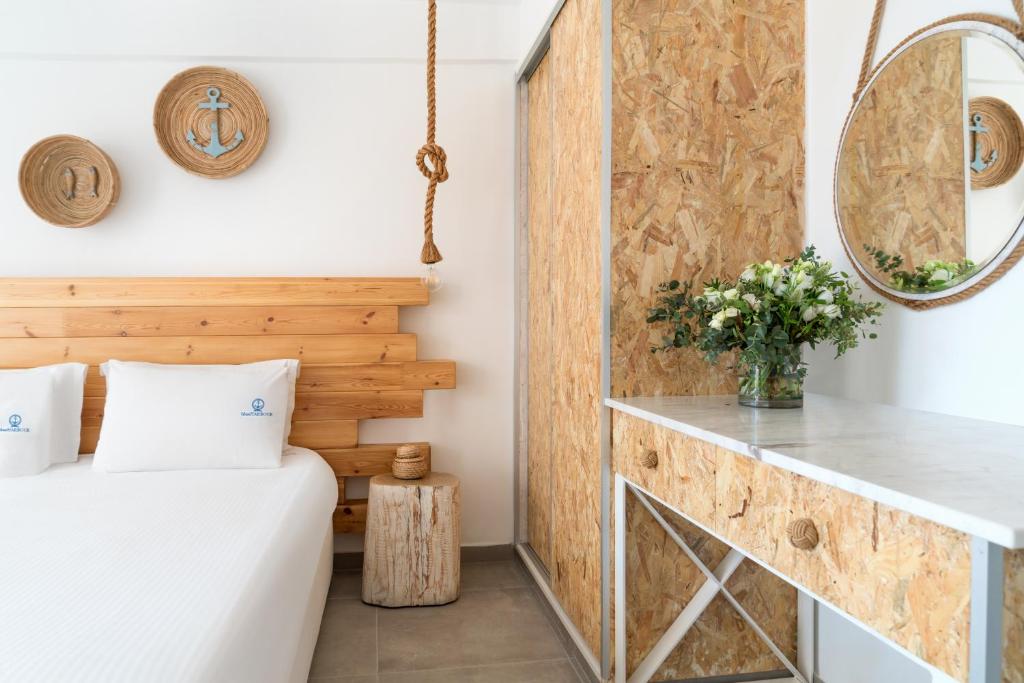 a room with a bed and a mirror at Blue Harbour Boutique in Ayia Napa