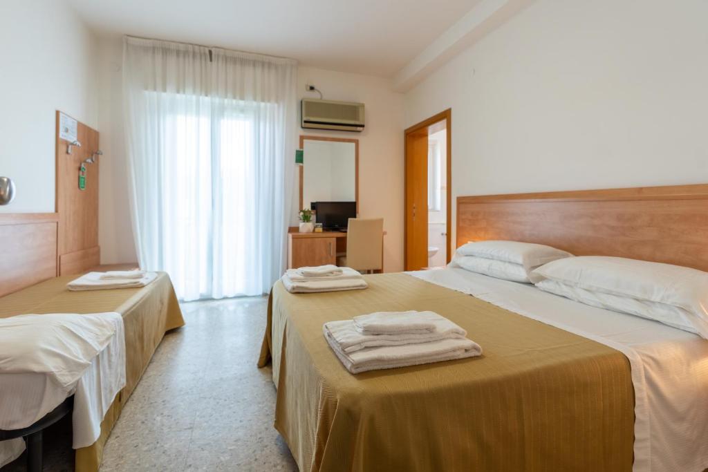 Postel nebo postele na pokoji v ubytování Hotel La Pineta