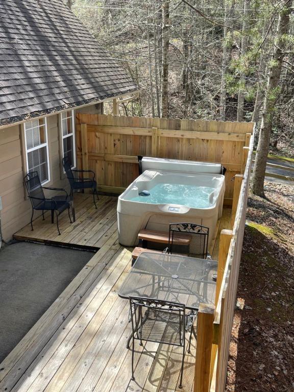 a hot tub sitting on a wooden deck at Beary Charming in Gatlinburg