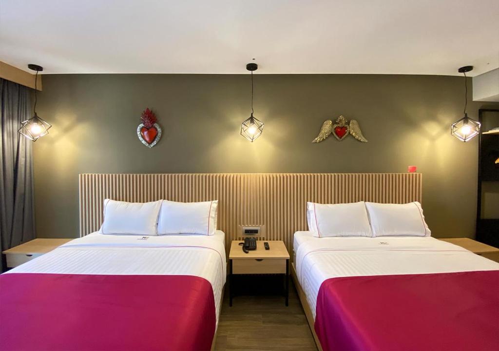 Postel nebo postele na pokoji v ubytování Hotel MX más san miguel de allende