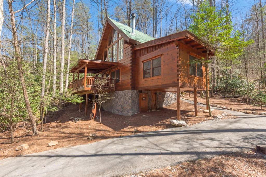 a tree house in the woods with a driveway at Bear Paw Trail in Sevierville