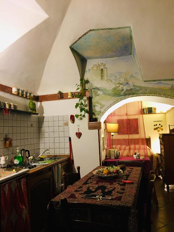 a kitchen with a table with a plate of food on it at LaTanaSegreta in Monterotondo