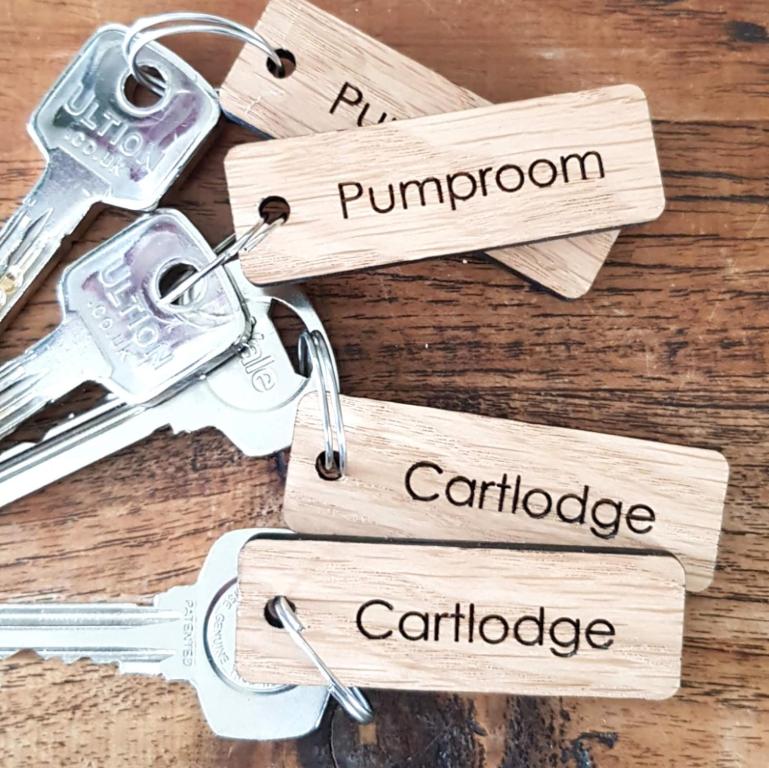 a bunch of keys on a wooden table at Lauriston Stay in Birch