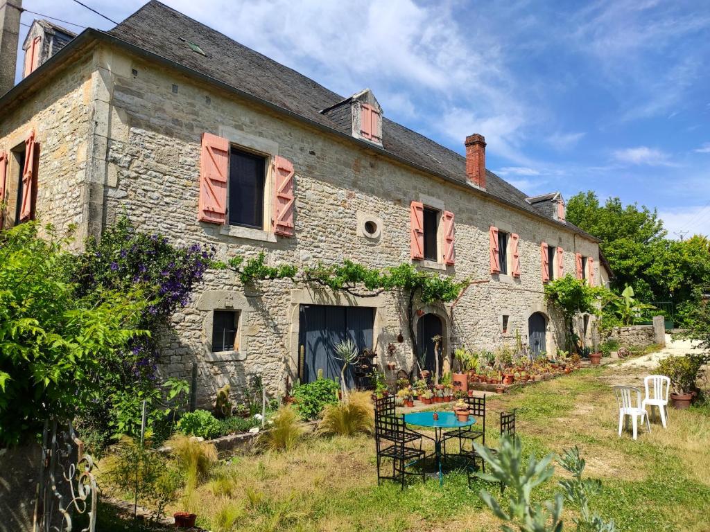 an old stone house with a table in front of it at Le Cactus Orange Chambre d'hôte entrée indépendante in Cressensac