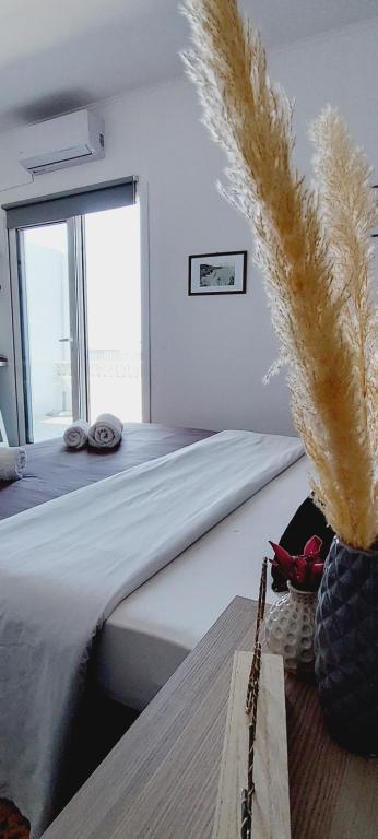 a bedroom with a bed with feathers on it at Fatolitis Studios in Masouri