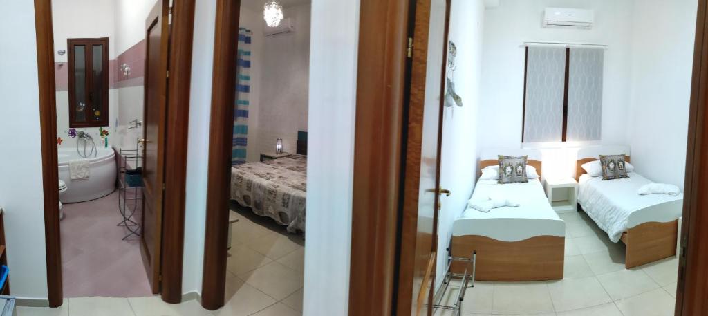 Postel nebo postele na pokoji v ubytování B&B AMURI RANNI